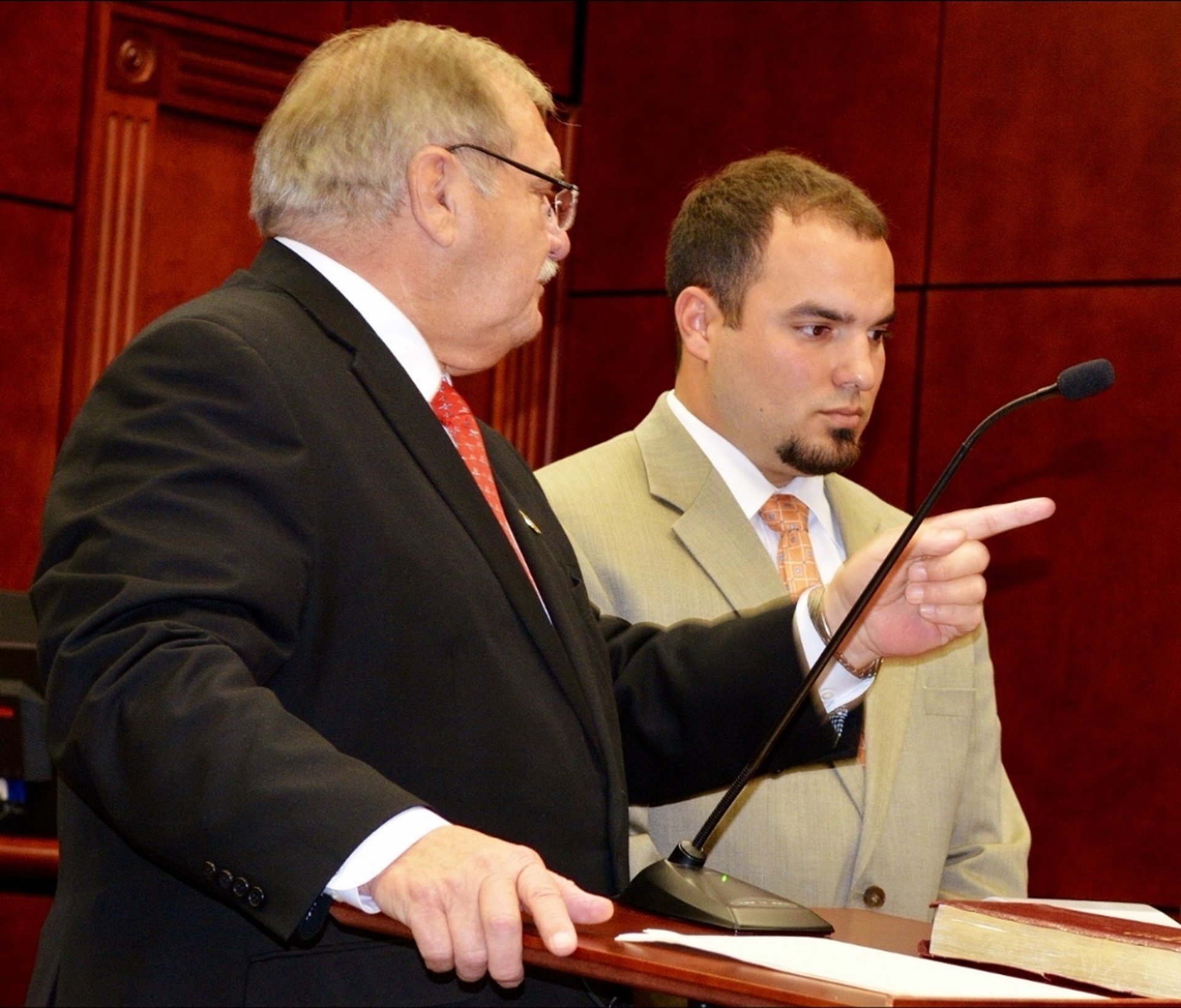 George W. Weaver arguing at podium with George W. Weaver Jr. beside him